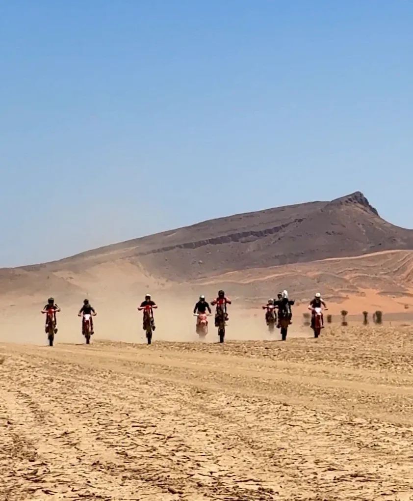 Enduro expedition team crossing open Sahara terrain Enduro motorcycle in desert terrain: Foum Zguid — Merzouga — Dadès