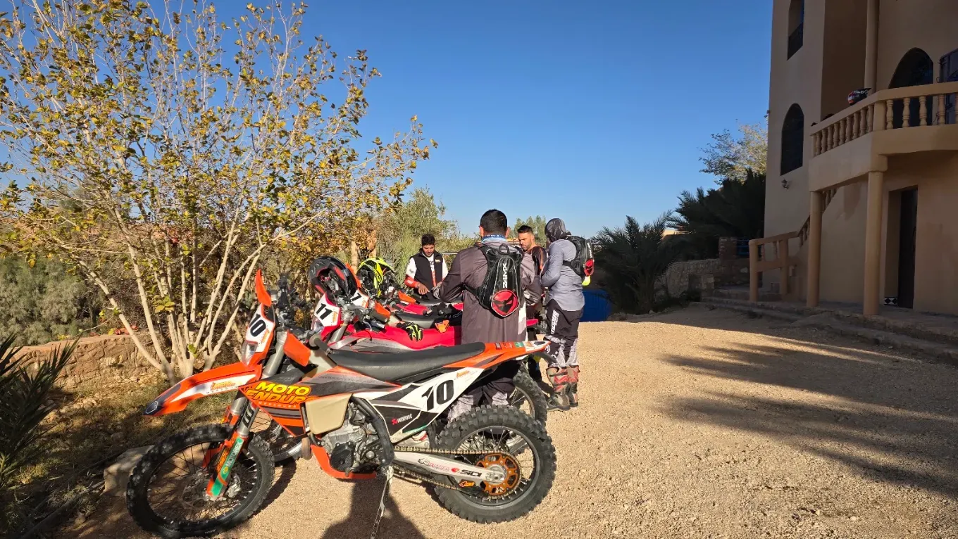 KTM enduro fleet prepared for a guided Merzouga desert tour Orange enduro motorcycle prepared for rocky terrain